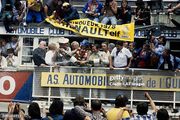 Didier Pironi and Jean-Pierre Jaussaud, 1st position, spray champagne on the podium during the 24 Hours of Le Mans at Circuit de la Sarthe on June...