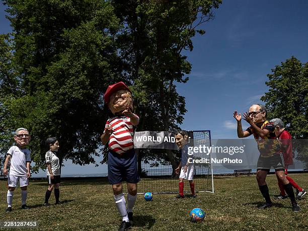 Oxfam activists dressed up with caricature "big heads" and national football colours representing the G7 heads of state and governments Prime...