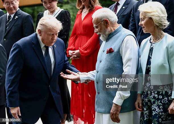 Indian Prime Minister Narendra Modi offers a hand to U.S. President Donald Trump during a family photo during the G7 Summit on June 16, 2026 in...