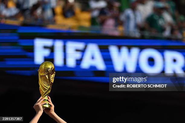 Fan shows a replica of the FIFA World Cup trophy ahead of the 2026 World Cup Group J football match between Argentina and Algeria at the Kansas City...