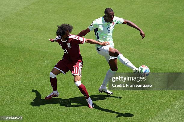 Denis Zakaria of Switzerland is challenged by Akram Afif of Qatar during the FIFA World Cup 2026 Group B match between Qatar and Switzerland at San...