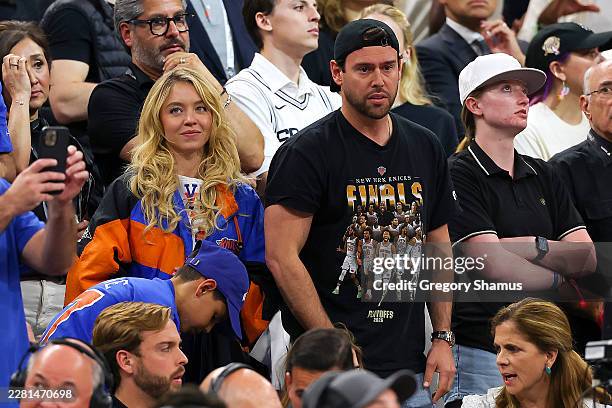 Sydney Sweeney and Scooter Braun look on during the fourth quarter in Game Five of the 2026 NBA Finals between the San Antonio Spurs and the New York...