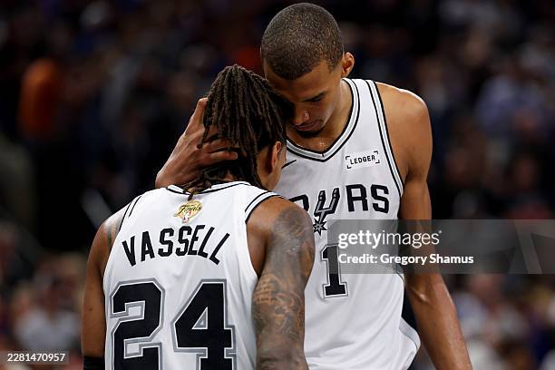 Devin Vassell and Victor Wembanyama of the San Antonio Spurs react during the fourth quarter against the New York Knicks in Game Five of the 2026 NBA...