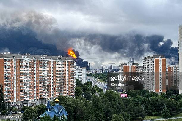 Black smoke rises from the area of the Russian oil producer Gazprom Neft's Moscow oil refinery on the south-eastern outskirts of Moscow on June 18,...