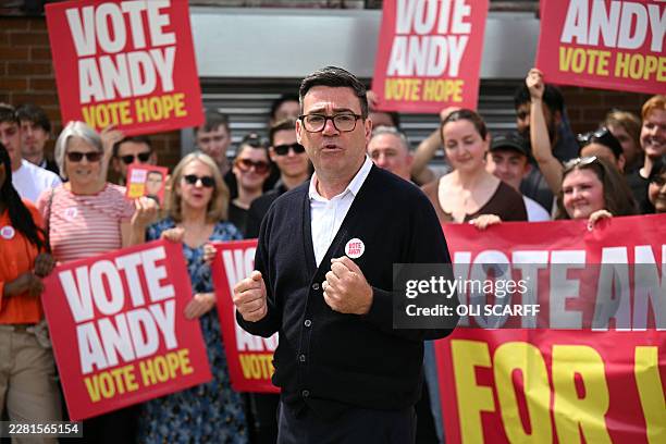 Labour party candidate Andy Burnham addresses supporters outside the Labour party campaign office in Ashton in Makerfield, northwest England, on June...