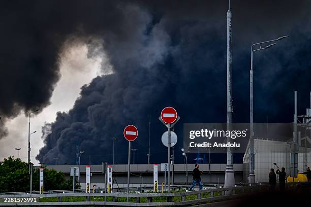 Black smoke rises from the refinery where a fire broke out following a strike as firefighting efforts continue in Moscow, Russia on June 18, 2026....