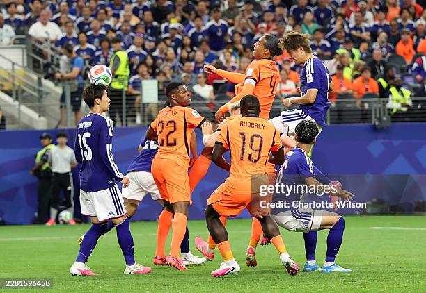 Koki Ogawa of Japan heads the ball, which is deflected off the head of Daichi Kamada for the team's second goal during the FIFA World Cup 2026 Group...