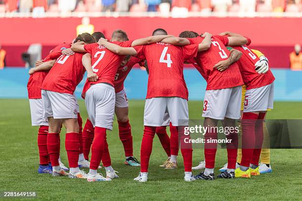 soccer team huddling before match on field - huddling stock pictures, royalty-free photos & images