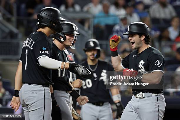 Andrew Benintendi of the Chicago White Sox celebrates hitting a grand slam in the eighth inning against the New York Yankees at Yankee Stadium on...