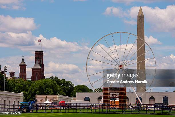 Smithsonian Castle and the Washington Monument are visible as a Ferris wheel is constructed as part of Freedom 250's Great American State Fair on the...