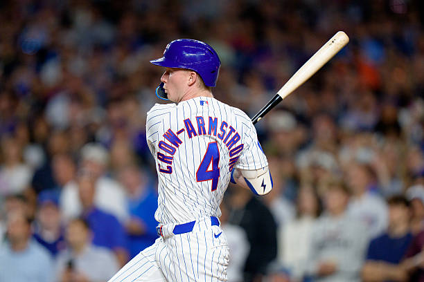 Pete Crow-Armstrong of the Chicago Cubs hits a single to complete the cycle in the seventh inning against the Colorado Rockies at Wrigley Field on...