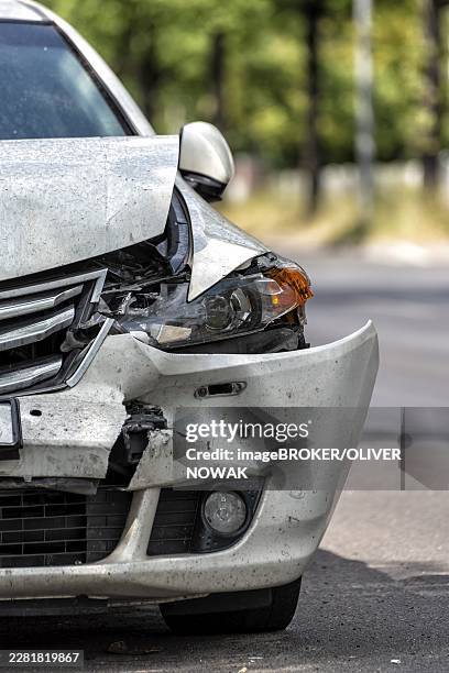 badly damaged car on the side of the road after an accident - parachoques fotografías e imágenes de stock