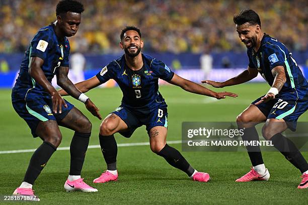 Brazil's forward Matheus Cunha celebrates with Brazil's forward Vinicius Junior and Brazil's midfielder Lucas Paqueta after scoring his team's second...