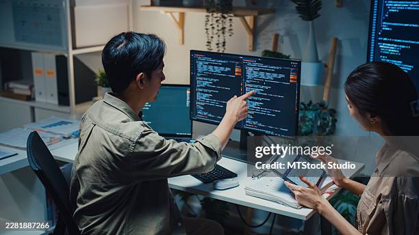 team young asian computer programmers discuss software development working late at night in the office. partnership teamwork plan, artificial intelligence data science, business connection concepts. - python code stock pictures, royalty-free photos & images