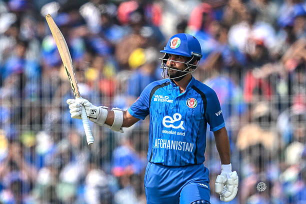 Afghanistan's captain Hashmatullah Shahidi celebrates after scoring a half-century during the third one-day international cricket match between India...