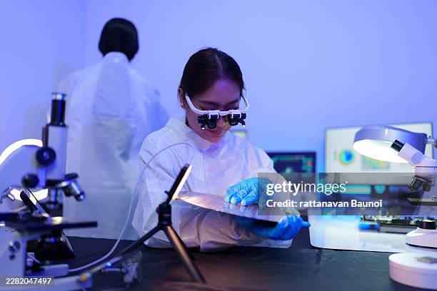 technician working on analyzing semiconductor or microchip boards, electronics industry, electronic engineer, computer technology, cpu maintenance, hardware, motherboard component upgrades. - optical lab stock pictures, royalty-free photos & images