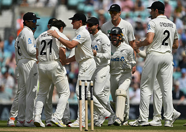 New Zealand's Matt Henry celebrates with teammates after dismissing England's Joe Root on the fifth day of the second cricket Test match between...