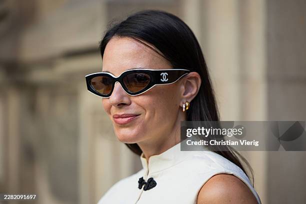 Zina Charkoplia wears white sleeveless top and pants Uara, Armet sandals, Hermes bag, Chanel sunglasses on June 17, 2026 in Barcelona, Spain.