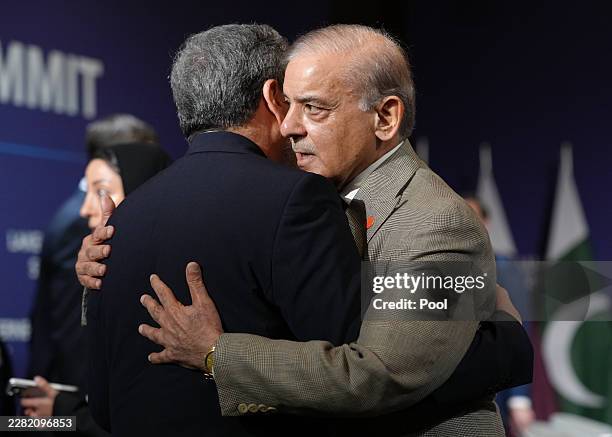 Iran's Foreign Minister Abbas Araqchi and Pakistan's Prime Minister Shehbaz Sharif greet each other before the start of a quadrilateral meeting...