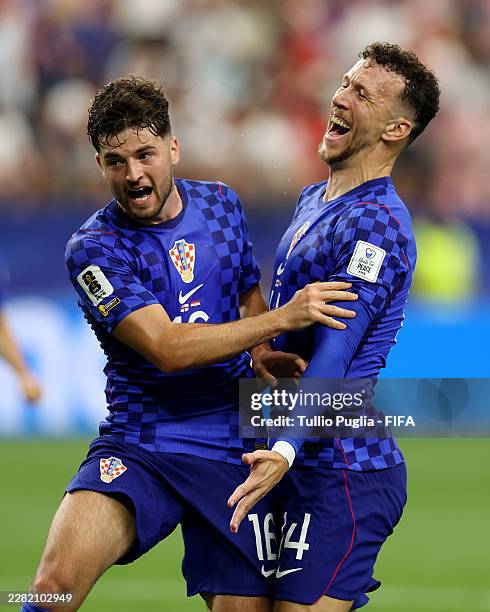 Martin Baturina of Croatia celebrates scoring his team's second goal with teammate Ivan Perisic during the FIFA World Cup 2026 Group L match between...
