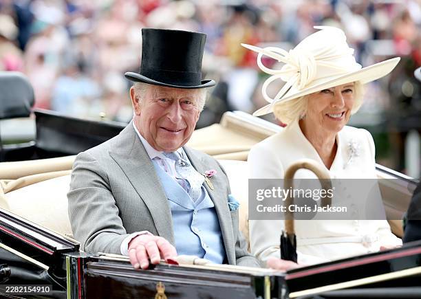 King Charles III and Queen Camilla smile as they attend day two of Royal Ascot 2026 at Ascot Racecourse on June 17, 2026 in Ascot, England.