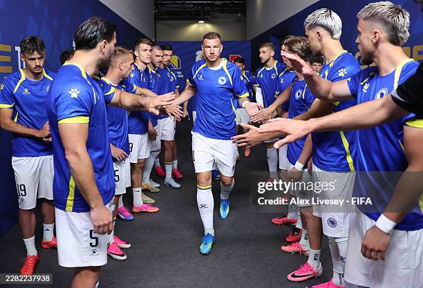 Edin Dzeko of Bosnia and Herzegovina high fives teammates in the tunnel as they prepare to warm up before the FIFA World Cup 2026 Group B match...