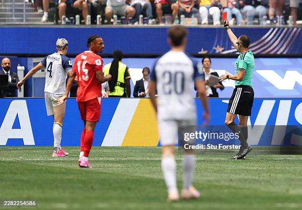 Referee Joao Pinheiro issues a red card to Tarik Muharemovic of Bosnia and Herzegovina during the FIFA World Cup 2026 Group B match between...
