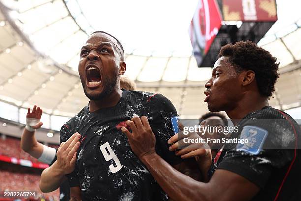 Cyle Larin of Canada celebrates with teammates after scoring his team's first goal during the FIFA World Cup 2026 Group B match between Canada and...