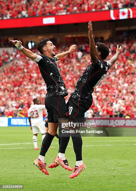 Jonathan David of Canada celebrates with teammate Stephen Eustaquio after scoring his team's third goal during the FIFA World Cup 2026 Group B match...