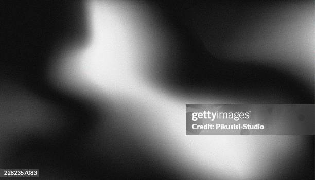 abstract dark moody black and white grainy gradient background, modern monochromatic fluid blurry backdrop with a noisy texture - dramatic spotlight stock illustrations