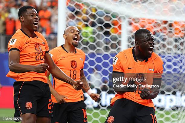 Brian Brobbey of the Netherlands celebrates with teammates Donyell Malen and Denzel Dumfries after scoring his team's first goal during the FIFA...