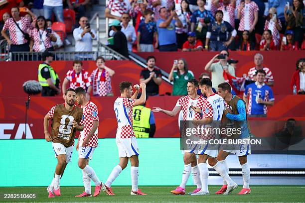 Croatia's forward Ante Budimir celebrates with teammates scoring his team's first goal during the 2026 World Cup Group L football match between...