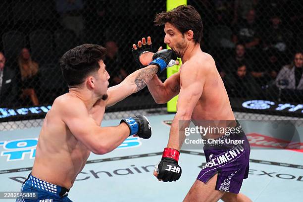 Mitch Raposo punches Allan Nascimento of Brazil in a flyweight fight during the UFC Fight Night event at Meta APEX on June 20, 2026 in Las Vegas,...