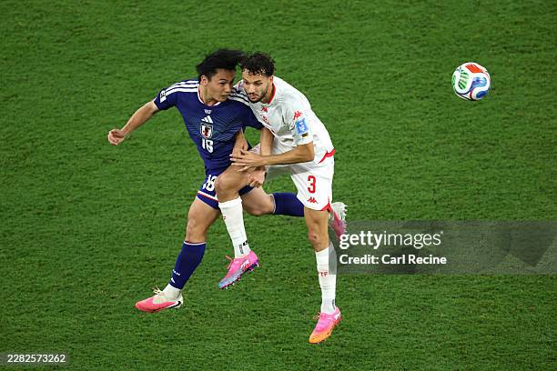 Ayase Ueda of Japan and Montassar Talbi of Tunisia compete for a header during the FIFA World Cup 2026 Group F match between Tunisia and Japan at...