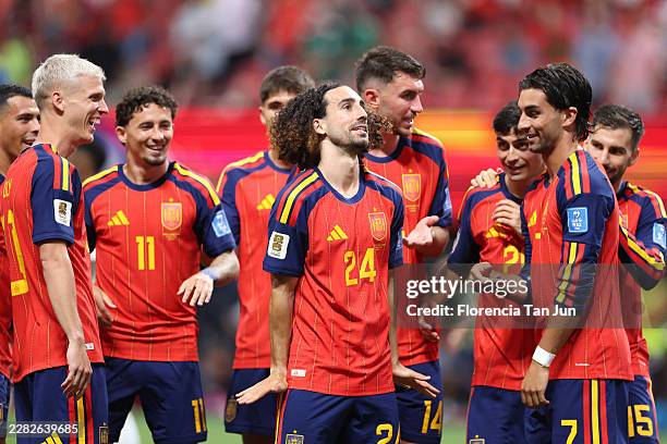 Marc Cucurella of Spain celebrates with teammates after the team's fourth goal, scored an own goal by Hassan Al-Tambakti of Saudi Arabia during the...