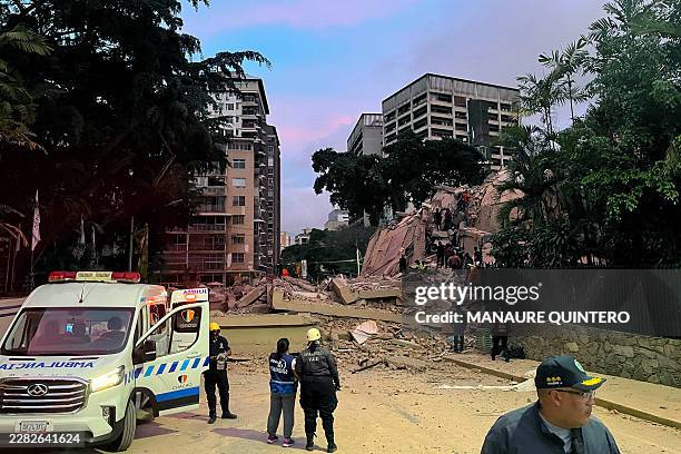 Rescuers search for victims in a collapsed building following an earthquake in Caracas on June 24, 2026. Two earthquakes of magnitude 7.2 and 7.5...