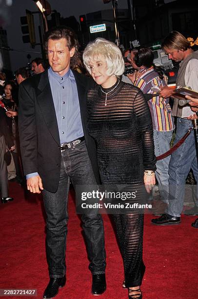 American singer-songwriter Randy Travis and Mary Elizabeth 'Lib' Hatcher-Travis attend the local premiere of Jan de Bont's 'Twister' at the Mann...