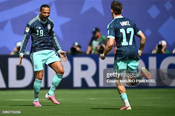 Germany's forward Leroy Sane celebrates with teammate midfielder Florian Wirtz scoring his team's first goal during the 2026 World Cup Group E...