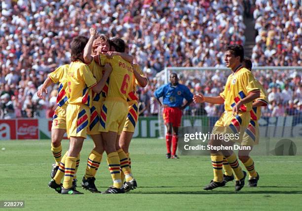 FLORIN RADUCIOIU OF ROMANIA CENTRE IS CONGRATULATED BY HIS TEAMMATES AFTER SCORING THE OPENING GOAL DURING THE COLOMBIA VERSUS ROMANIA MATCH AT THE...