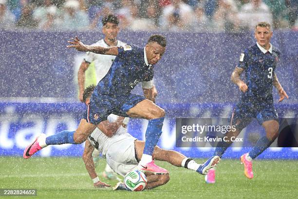 Kylian Mbappe of France is tackled by Hussein Ali of Iraq during the FIFA World Cup 2026 Group I match between France and Iraq at Philadelphia...