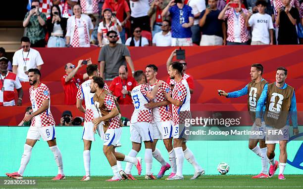 Ante Budimir of Croatia celebrates with teammates after scoring the team's first goal during the FIFA World Cup 2026 Group L match between Panama and...