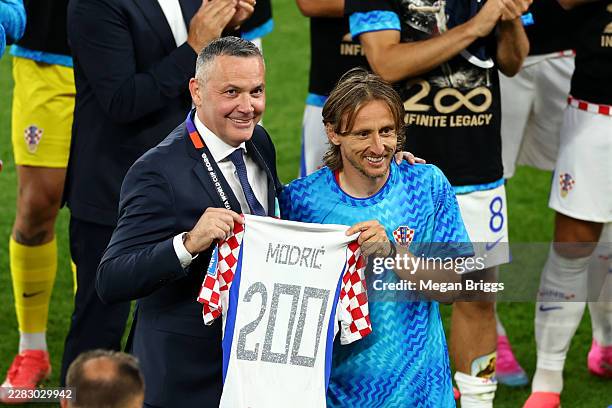 Croatian Football Federation President Marijan Kustic presents Luka Modric of Croatia with a shirt marking his 200th cap during the FIFA World Cup...