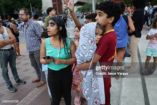 Evacuated people wait at Parque Central urban development complex after a magnitude 7.2 earthquake struck Venezuela and other regions in the...