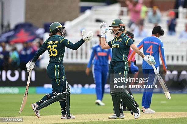 Australia's Georgia Wareham and Australia's Ashleigh Gardner celebrate after beating India in the ICC Women's T20 cricket world cup 2026 game between...