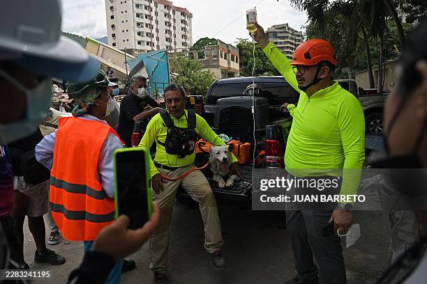 Rescue dog 'Tsunami' receives hydration after long hours of work in Caraballeda, La Guaira State, Venezuela on June 28 following twin earthquakes....