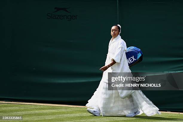 Japan's Naomi Osaka arrives to play against France's Elsa Jacquemot during their women's singles first round tennis match on the first day of the...