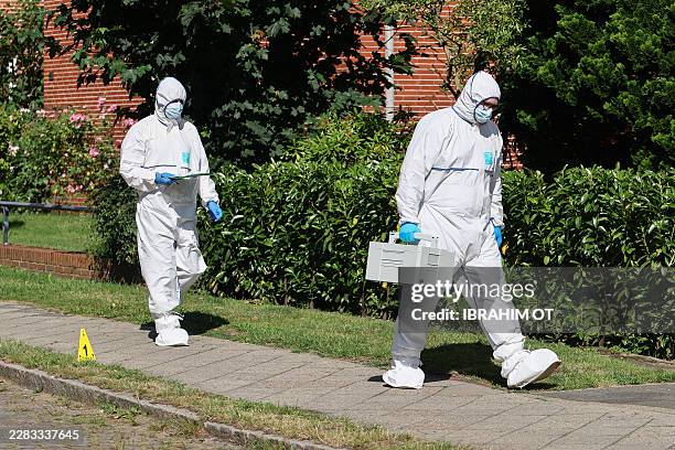 Forensic Police officers work at the scene where five people were killed in a shooting in Stade, northern Germany, a city some 50 kilometres west of...