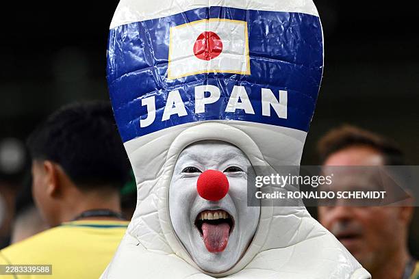 Japan's supporter poses ahead of the 2026 World Cup round of 32 football match between Brazil and Japan at the Houston Stadium in Houston on June 29,...