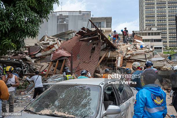 People in the street, rescue teams and damaged buildings are seen in Caracas, Venezuela, after two powerful earthquakes struck the region on June 25,...