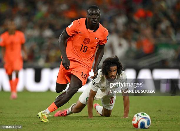 Netherlands' forward Brian Brobbey and Morocco's midfielder Ayyoub Bouaddi eye on the ball during the 2026 World Cup round of 32 football match...